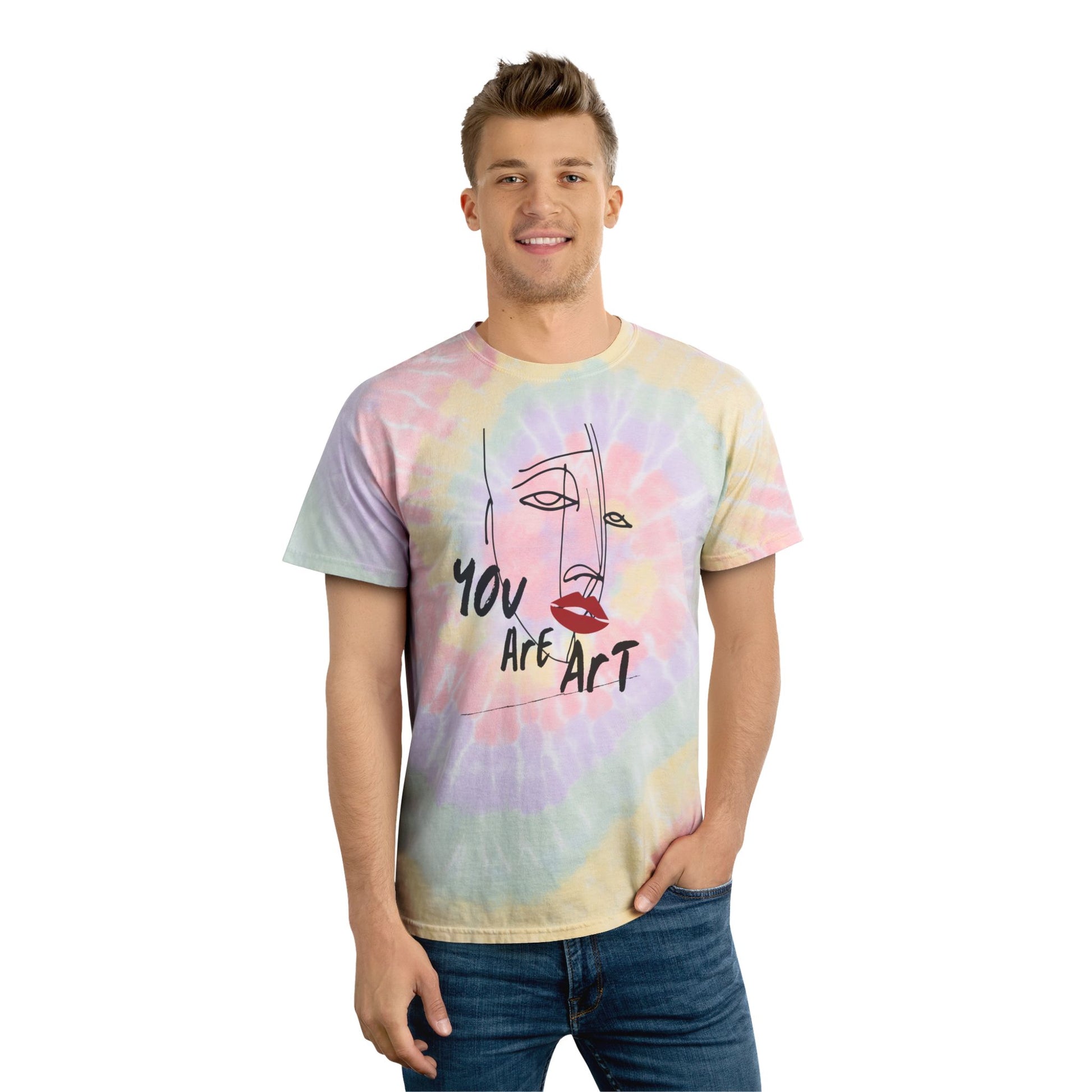 Person wearing a pastel spiral tie-dye unisex T-shirt featuring an abstract line art face graphic with "You Are Art" text on a white background. Soft cotton graphic tee ideal for summer, music festivals, beach days, casual wear, artistic fashion, and unique gift ideas.