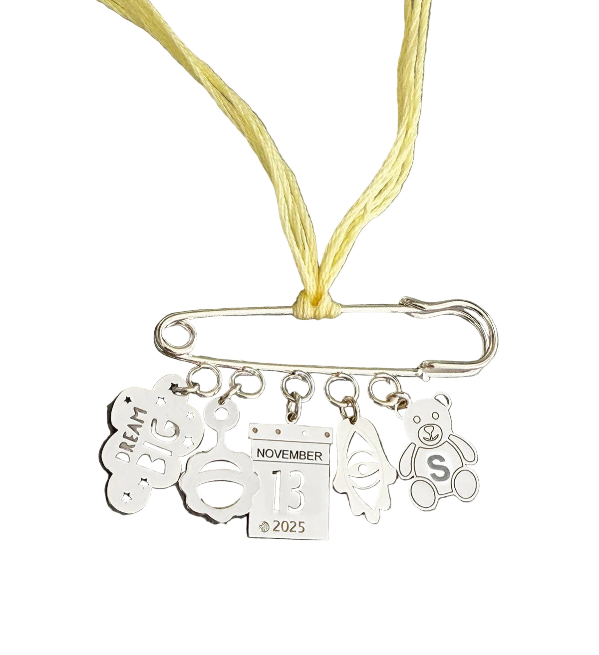 Necklace with safety pin and charms on a white background