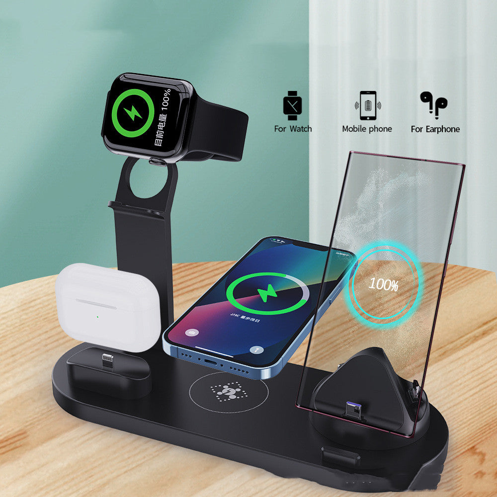 Multi-device wireless charging stand with smartphone, watch, and earbuds on a wooden surface.