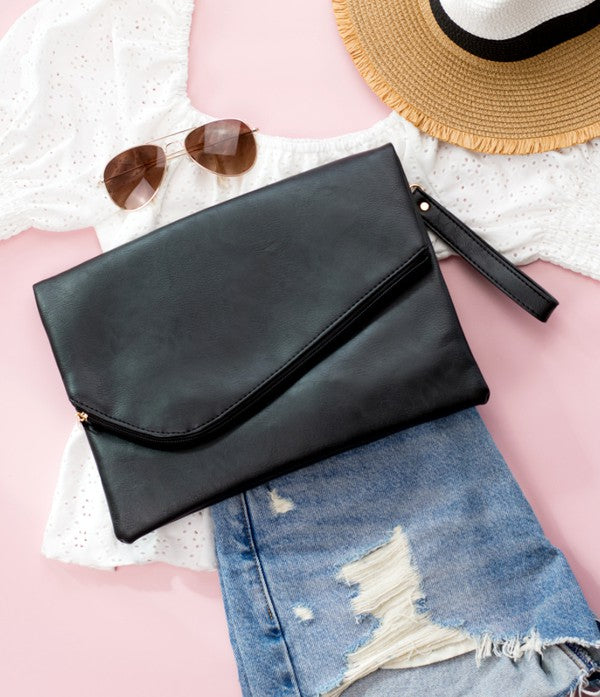 black foldover clutch bag Simple, sleek, and ready for whatever comes next. This oversized foldover envelope clutch is crafted from soft vegan PU with a fully lined, easy-wipe polyester interior. A top zipper envelope closure + snap keeps everything secure, and the removable wristlet makes carrying effortless.