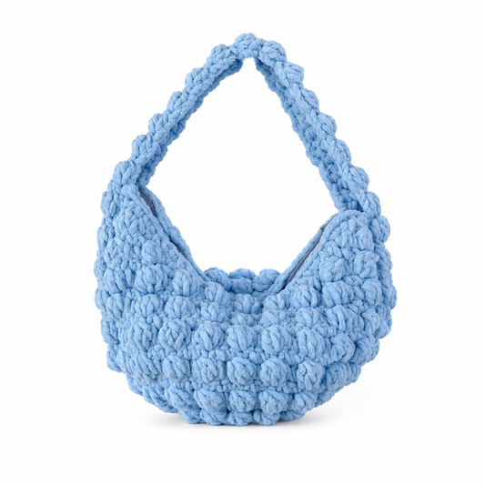 Blue textured handbag on a white background