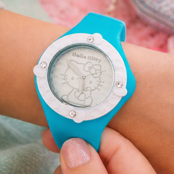 Person wearing a blue Hello Kitty watch on a pink textured background