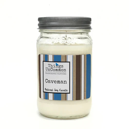 A 16 oz. Caveman Modern Mason Candle in a clear glass jar, featuring a minimalist label, sitting against a clean background.