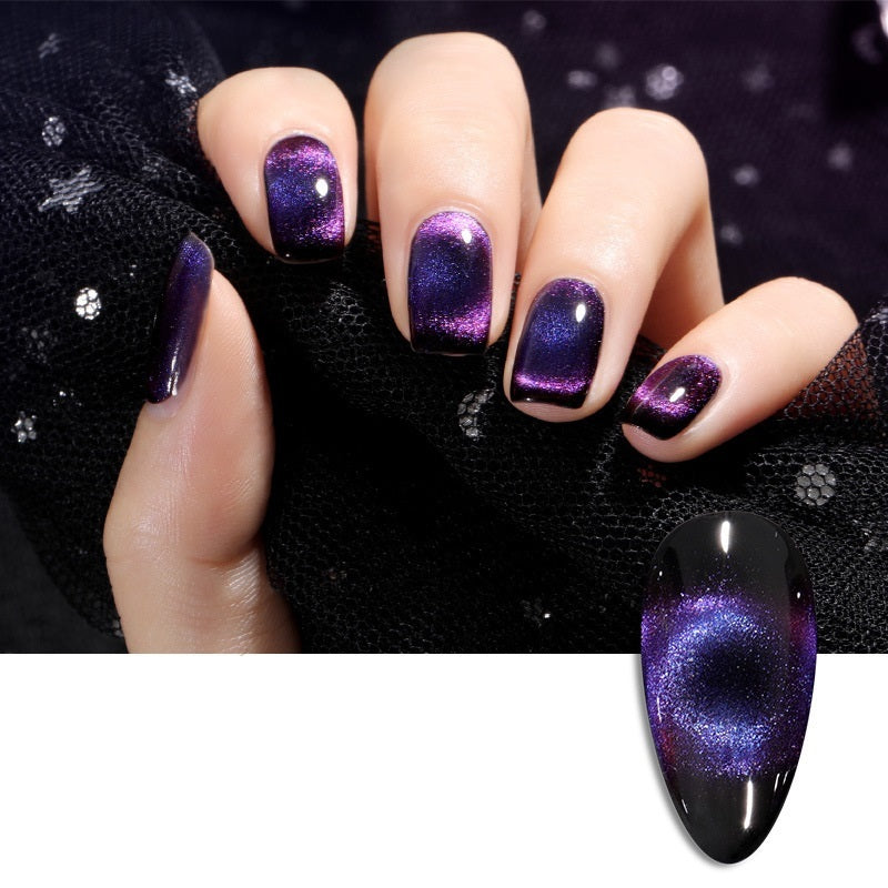 Elegant cat eye nail polish featuring a sophisticated purple and black gradient finish set against a sleek black background.