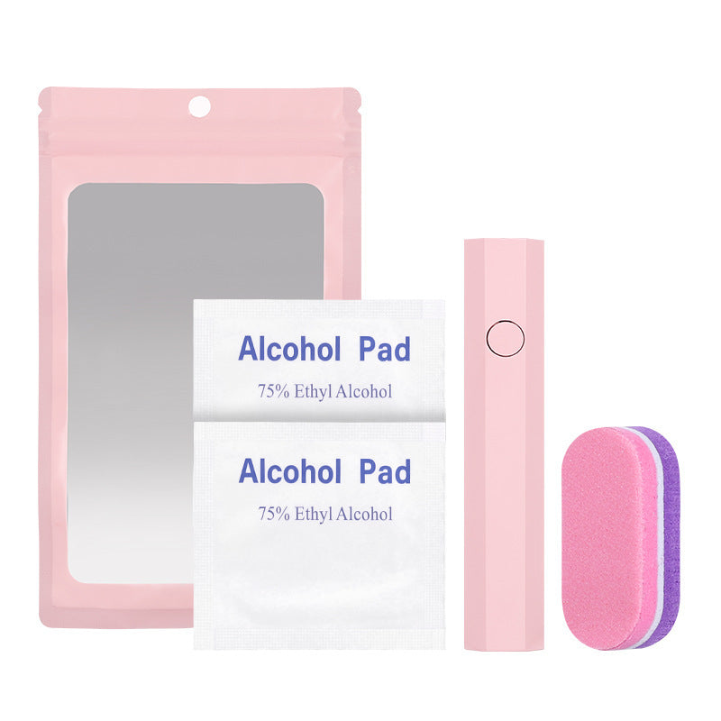 A pink beauty kit set containing a pink resealable pouch with a mirror, two white alcohol pads labeled 75% Ethyl Alcohol, a pink electric nail file, and a dual-sided pink and purple nail buffer, all arranged on a white background.