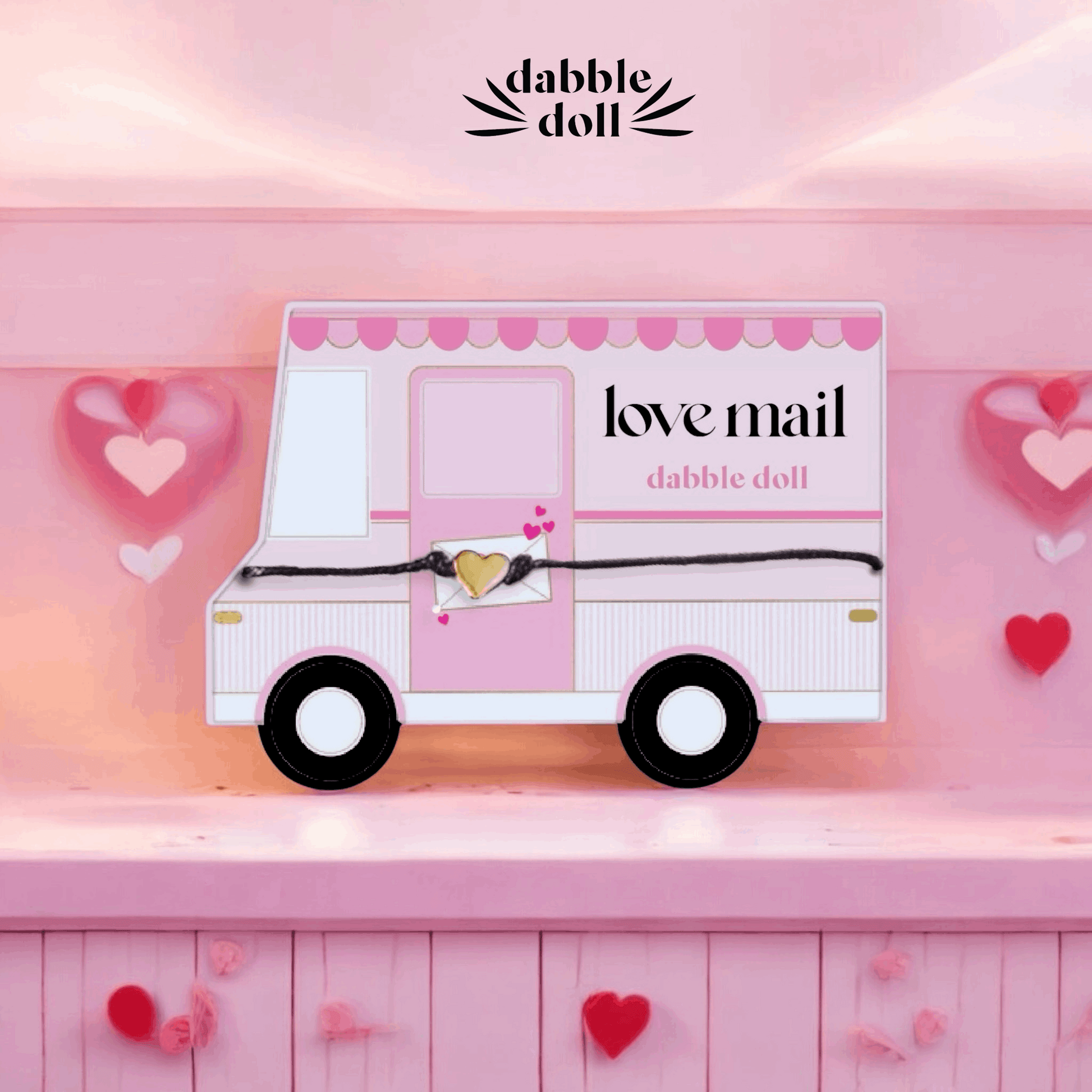 Toy truck with 'love mail' text on a pink background, featuring the brand 'dabble doll'.