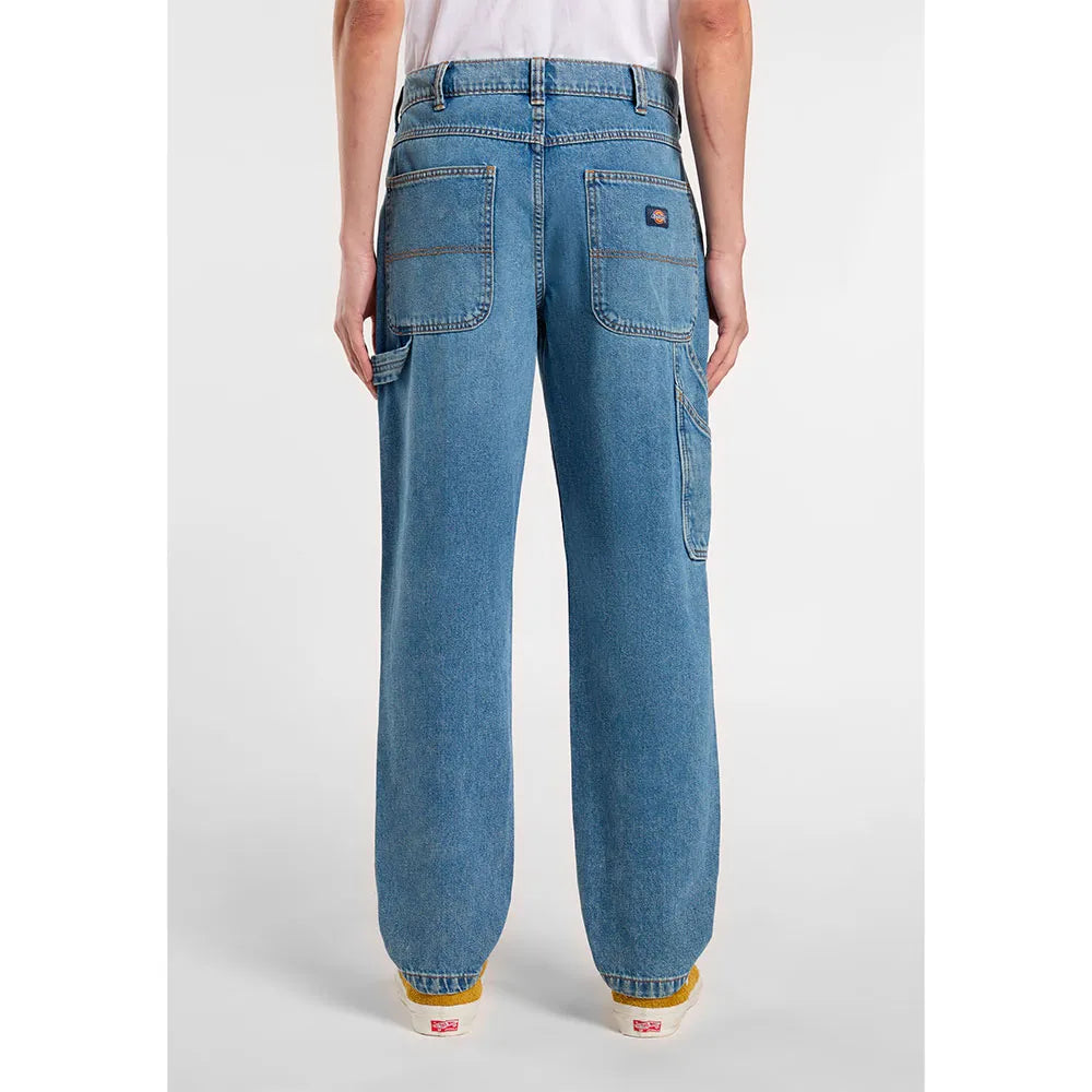 Blue jeans worn by a person on a white background