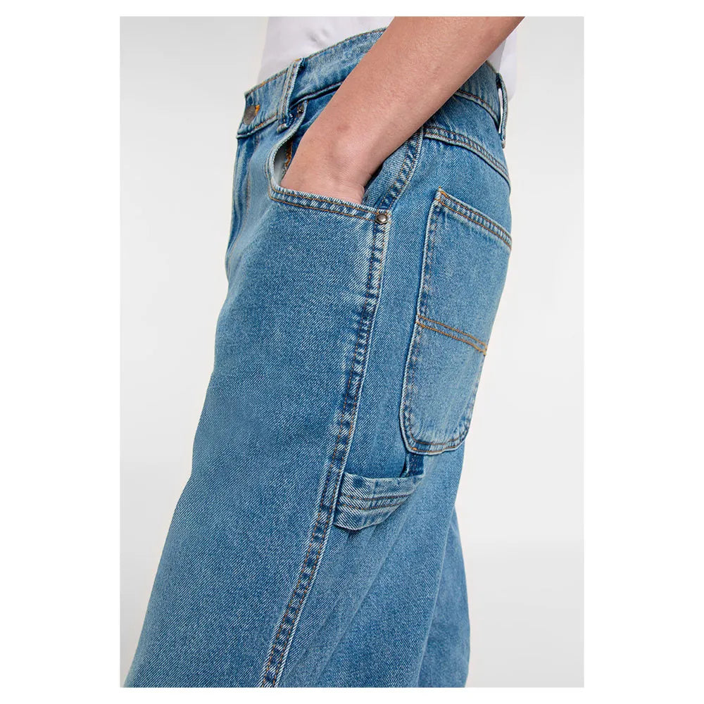 Close-up of blue jeans with a plain white background