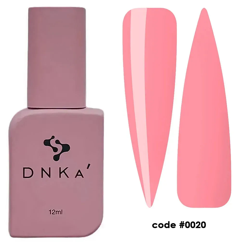 A high-angle product shot of a DNKa Fast Gel bottle in shade #0020 Oxford, featuring a pastel coral-pink gel swatch and matching nail form tips arranged artfully against a clean, minimalist white background.