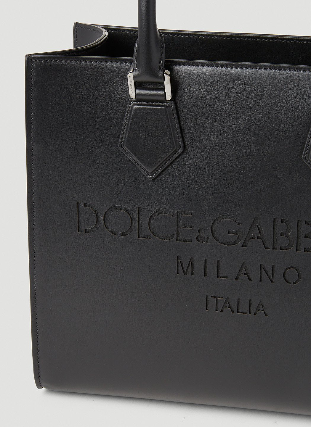Black Dolce & Gabbana handbag with branding on a light gray background