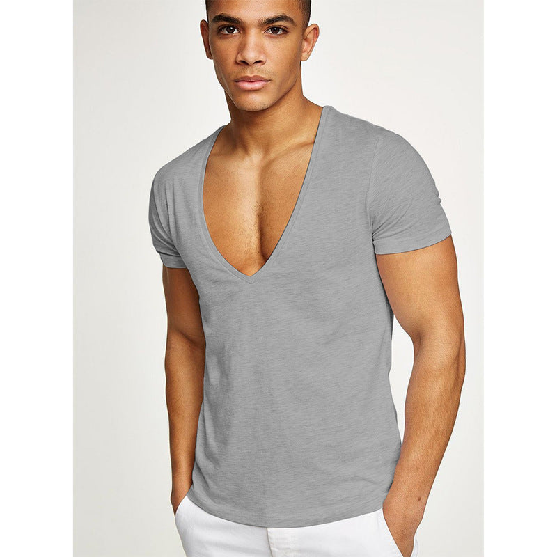 Man wearing a gray v-neck t-shirt against a white background