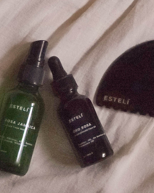 Two Esteli skincare bottles on a textured surface
