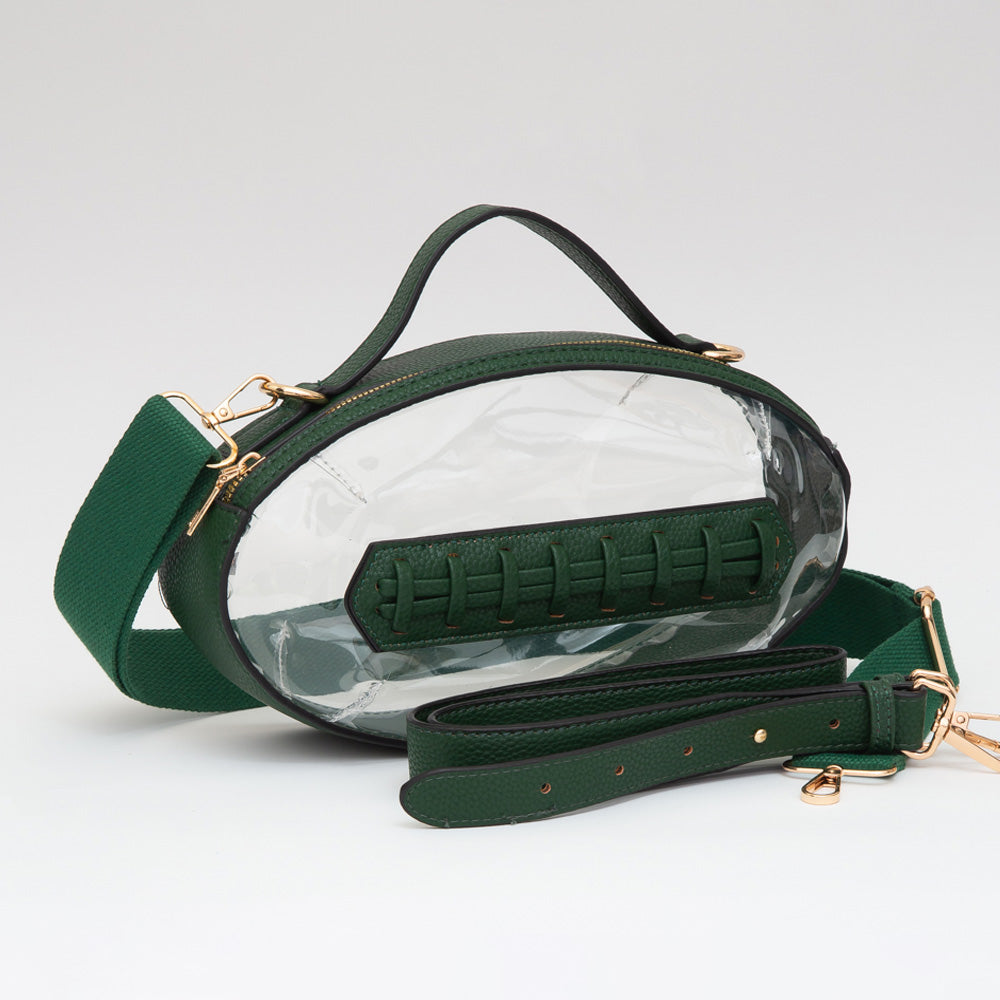 A football-shaped transparent crossbody bag featuring gold-tone hardware, a top handle, and two detachable, adjustable straps. The clear design is ideal for stadium security requirements, making it a stylish and practical accessory for game day events and travel.