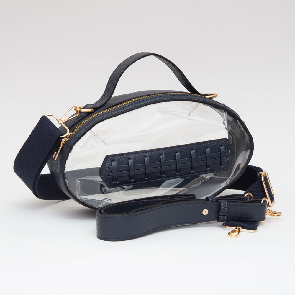 Clear handbag with black interior and strap on a light gray background