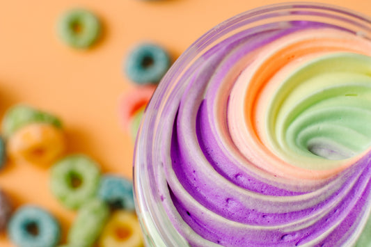 Close-up of a swirl of whipped body butter shea butter frut loops fruity body cream frosting with berries in the background