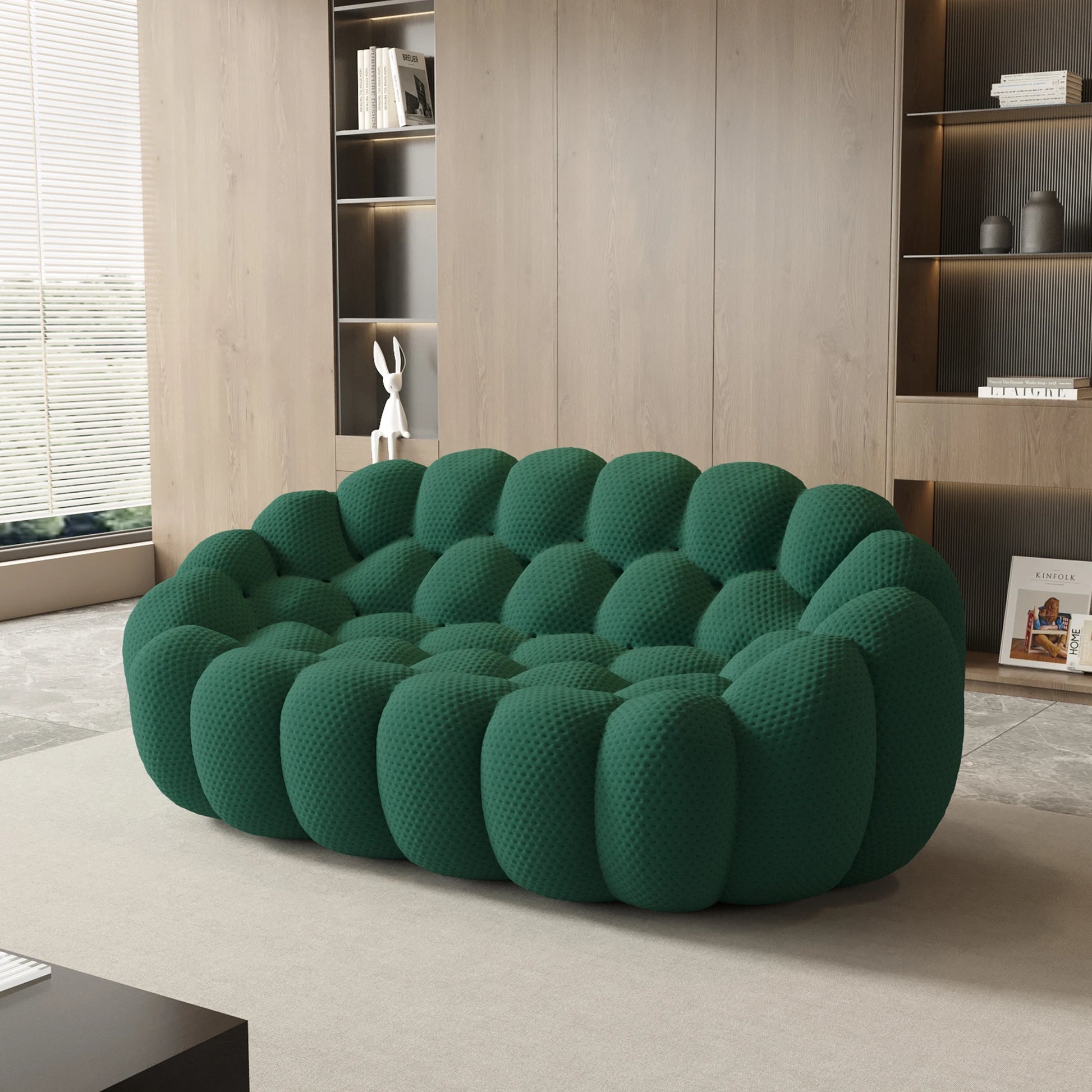 Green textured sofa in a modern living room with bookshelves.