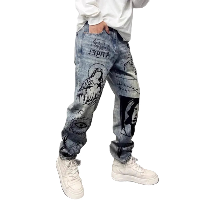 Person wearing jeans with graphic designs and white sneakers on a white background.