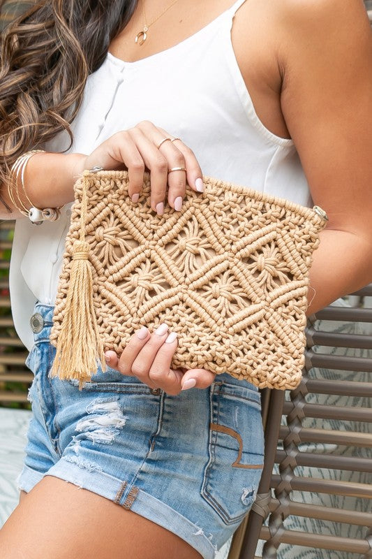 Carry your essentials in soft boho-chic style. This charming macramé clutch features intricate woven detailing, a lined interior that protects your items, and a hidden open pocket for the little things. Finished with a zip closure and a playful tassel accent—perfect for nights out or travel days.

Khaki colored Macrame Tassel Clutch Woven macramé clutch purse