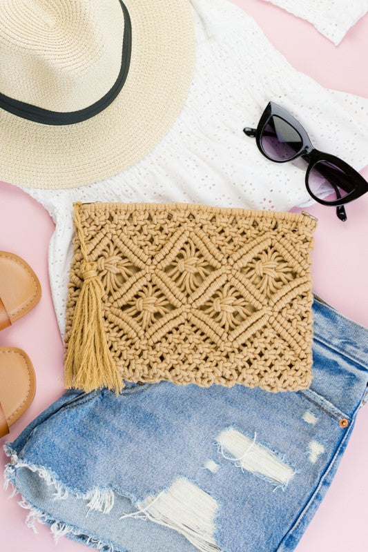Carry your essentials in soft boho-chic style. This charming macramé clutch features intricate woven detailing, a lined interior that protects your items, and a hidden open pocket for the little things. Finished with a zip closure and a playful tassel accent—perfect for nights out or travel days.

Macrame Tassel Clutch