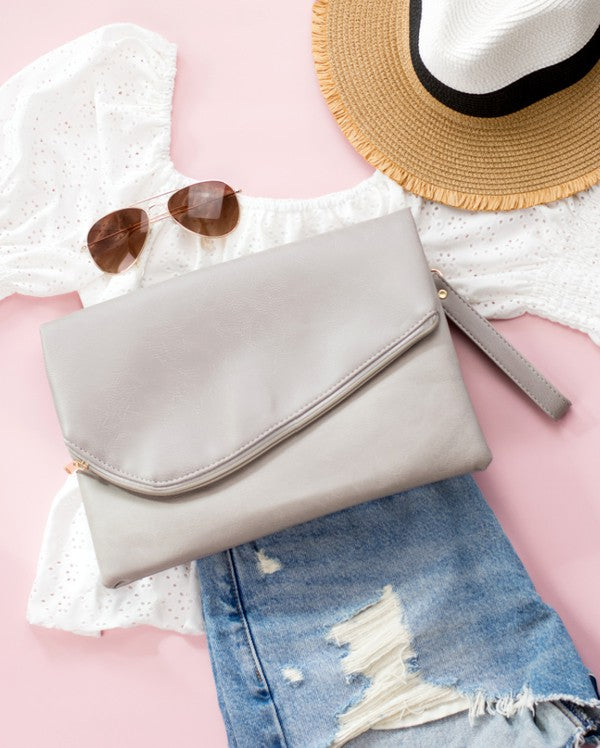 light foldover clutch bag Simple, sleek, and ready for whatever comes next. This oversized foldover envelope clutch is crafted from soft vegan PU with a fully lined, easy-wipe polyester interior. A top zipper envelope closure + snap keeps everything secure, and the removable wristlet makes carrying effortless.