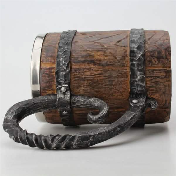 Wooden mug with metal handle and band on a white background