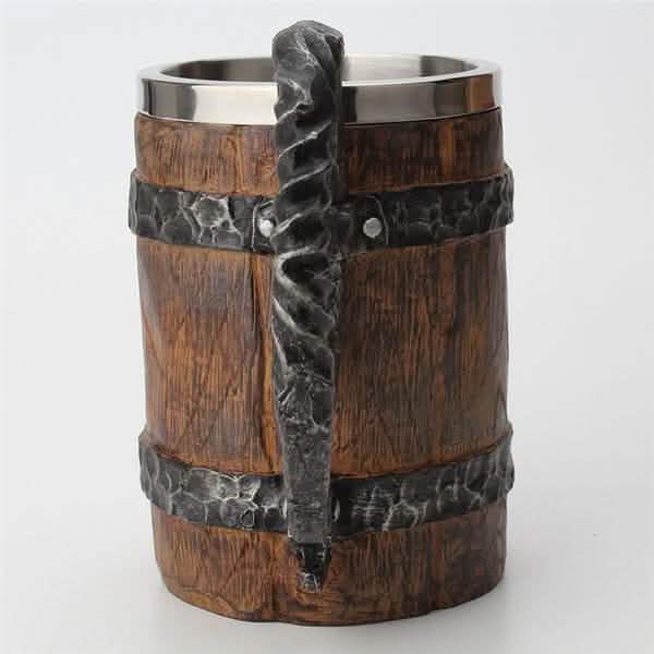 Wooden mug with metal handle and rim on a white background