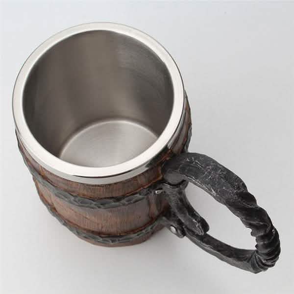 Metal mug with wooden handle on a light gray background