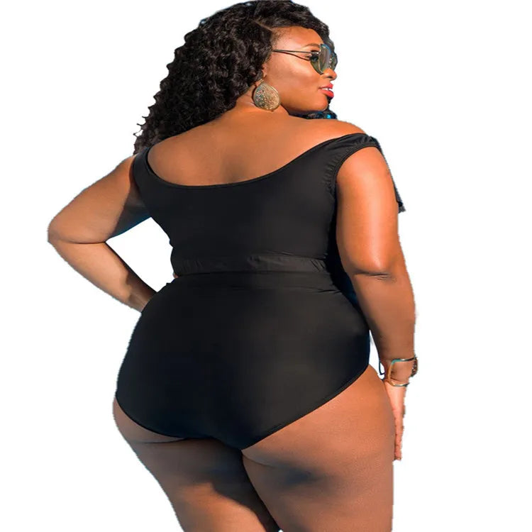 Woman wearing a black swimsuit on a white background