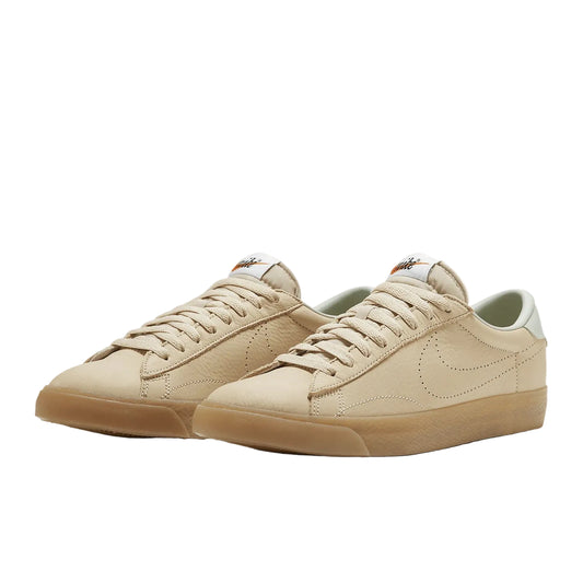 Pair of beige sneakers with a white background