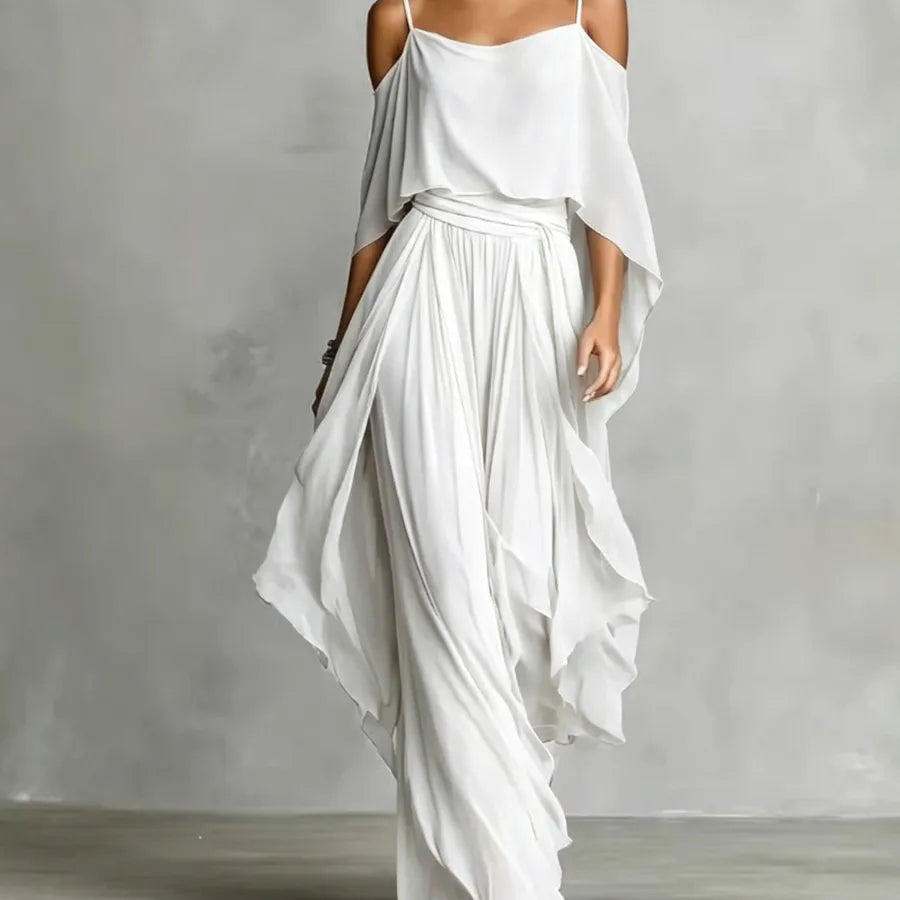 Flowing white chiffon women's two-piece co-ord set featuring an asymmetrical cold-shoulder camisole top and wide-leg pants, elegant resort wear for beach vacations, weddings, parties, and special occasions.