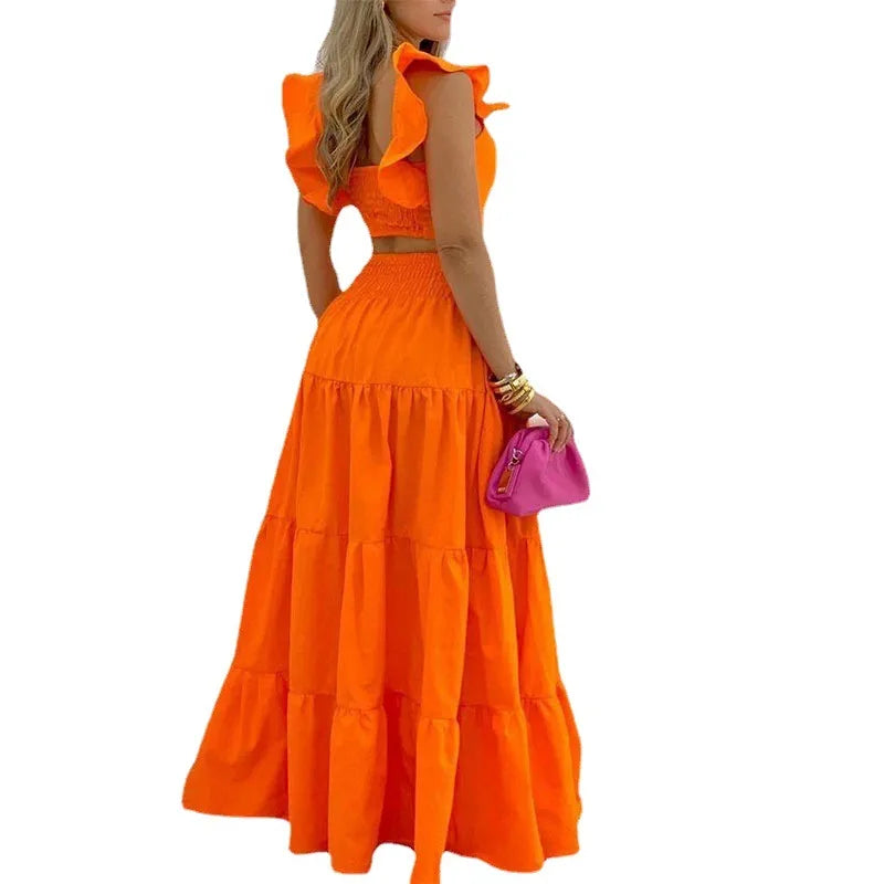 Orange ruffle sleeve two-piece maxi skirt set for women, back view, sleeveless crop top with smocked back, tiered high-waisted maxi skirt, summer vacation outfit, resort wear, boho fashion co-ord set, bright orange matching set, women's casual beach outfit