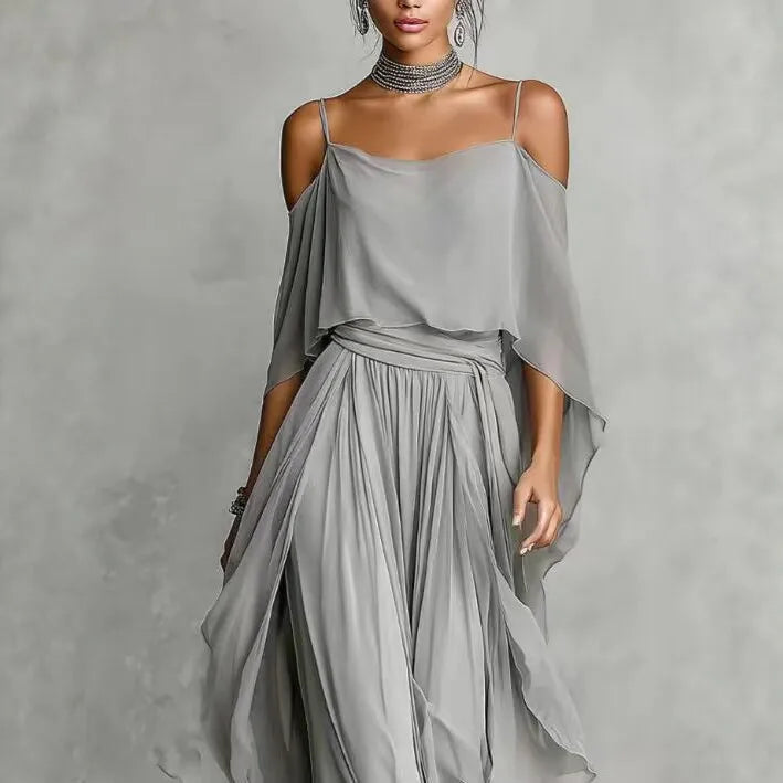 Luxury women's gray chiffon two-piece co-ord set featuring an asymmetrical cold-shoulder camisole top and wide-leg pants, elegant resort wear outfit.