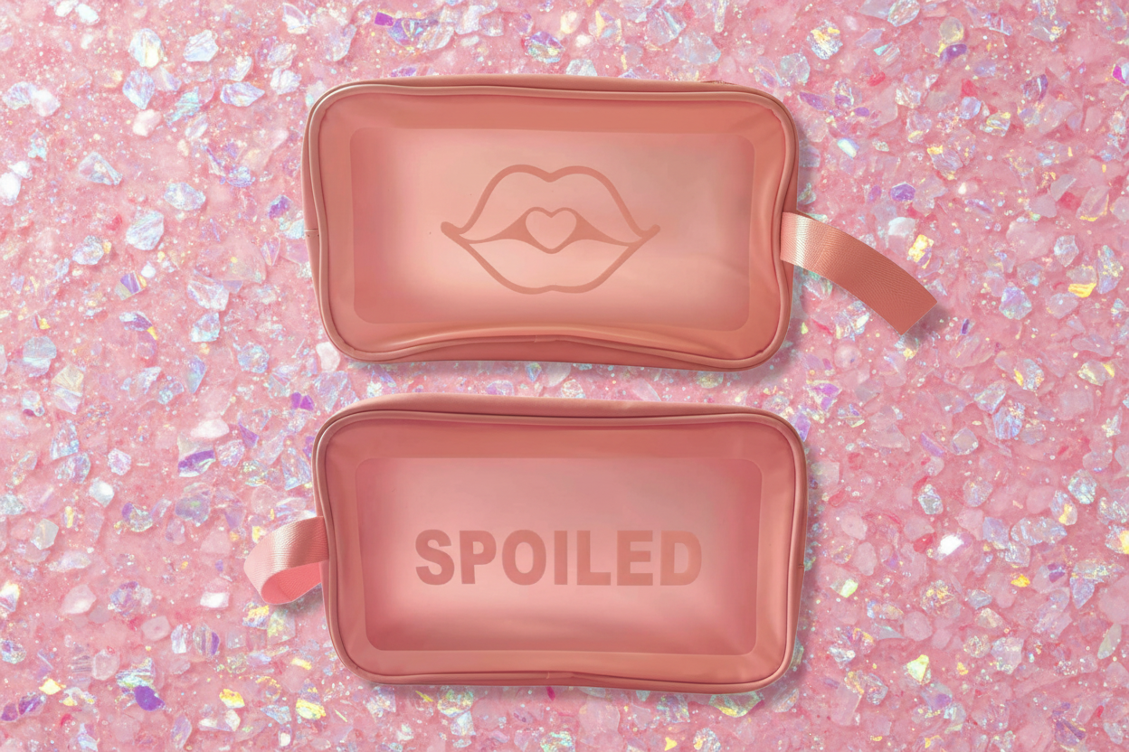Two pink cosmetic bags with a lip design and 'SPOILED' text on a white background
