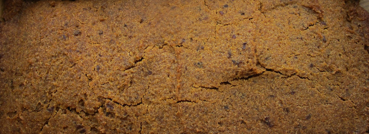 Loaf of bread in a cardboard box with bee-themed decorations in the background