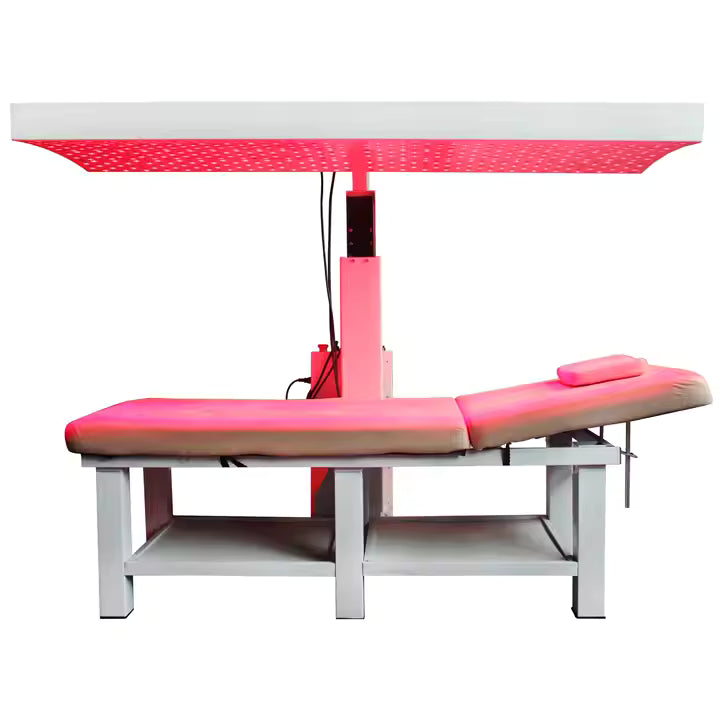 Pink and white medical examination table with a light above on a white background