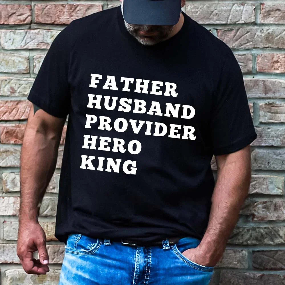 Man wearing a black t-shirt with text in front of a brick wall