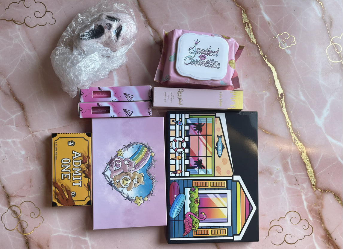 Collection of colorful boxes and a ghost-like figure on a wooden surface MYSTERY BOX SPOILED COSMETICS